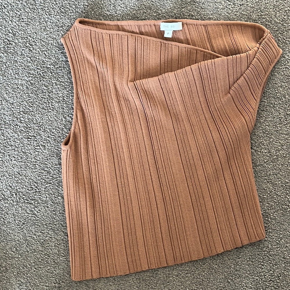 The Sei knit top, asymmetrical as it dips off one shoulder